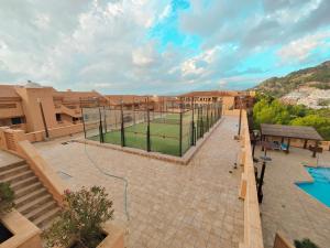 a tennis court in the middle of a courtyard at Luxury Apartments Mascarat in Altea