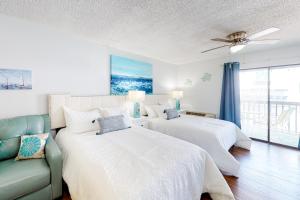 a bedroom with two beds and a couch at Seaward Villas 301 in Ocean City