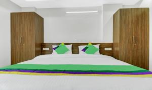 a bedroom with a large white bed with wooden headboards at Treebo Raga in Visakhapatnam +26 photos