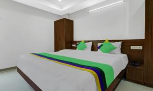 a bedroom with a bed with a rainbow on it at Treebo Trend Raga in Visakhapatnam