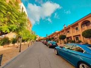 a blue car parked on the side of a street at Luxury Apartments Mascarat in Altea