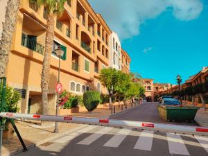 a street with a building and palm trees on a street at Luxury Apartments Mascarat in Altea