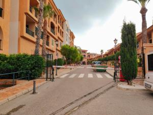 an empty street with palm trees and buildings at Luxury Apartments Mascarat in Altea
