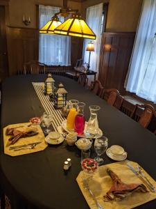 a black table with plates and glasses on it at The Marshall House in Niagara Falls
