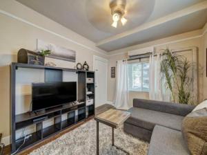 a living room with a large flat screen tv at Perfect Location Walking Distance to Everything in Sacramento