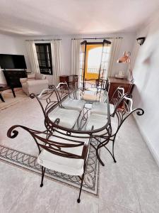 a glass table and chairs in a living room at Luxury Apartments Mascarat in Altea