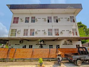 a house with a truck parked in front of it at Collection O 90253 DHelomi in Kalasan