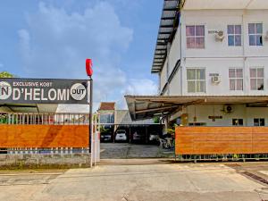 a building with a sign in front of a building at Collection O 90253 DHelomi in Kalasan