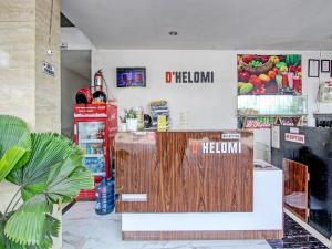 a mexican restaurant with a wooden door and a counter at Collection O 90253 DHelomi in Kalasan +26 photos