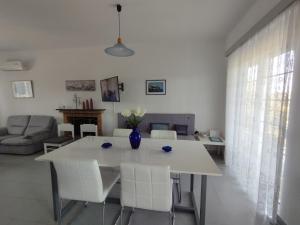 a white table and chairs in a living room at Aphrodite Villa Gennadi in Gennadi