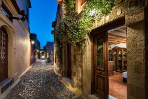 an alley in an old town at night at Mythic Spa Villa in Rhodes Town +19 photos