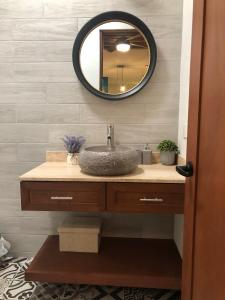 a bathroom with a sink and a mirror at Doña Jose Suite & Apartments in San Miguel de Allende