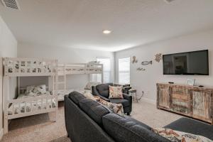 a living room with a couch and a bunk bed at Serenity Island Treasure At 7868 Evening Glow Drive in Pensacola