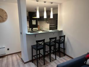 a kitchen with two stools at a counter in a room at Spacieux T2 avec parking à 200 m Cathédrale in Chartres