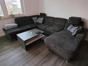 a living room with a couch and a coffee table at Leipziger Neuseenland Apartment in Markkleeberg