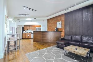 a living room with a couch and a table and a kitchen at The Havana Lofts in Philadelphia