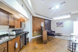 an open kitchen and living room in an apartment at The Havana Lofts in Philadelphia