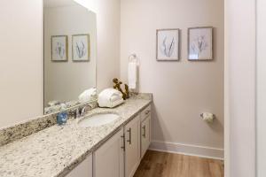 a bathroom with a sink and a mirror at Serenity Salty Intentions At 14334 Gardenglen Drive in Pensacola +47 photos