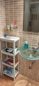 a bathroom with a sink and a mirror at Cozy Apartment close to the beach in beatiful area in El Perelló