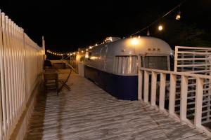 a train is parked next to a fence at night at BOHO Beach Club in Boqueron