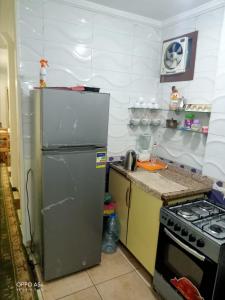 a kitchen with a refrigerator and a stove at Aatun flat in Miami families only in Alexandria