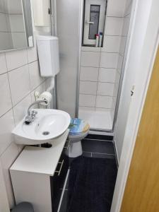 a small bathroom with a sink and a toilet at Ferienwohnung Kassel Zentral in Kassel