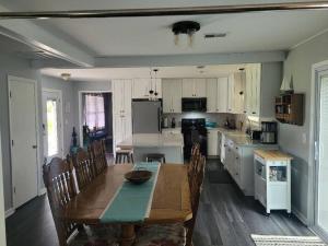 a kitchen with a wooden table and a dining room at Wilmington Family Vacation Home in Wilmington