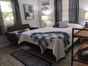 a bedroom with a bed and a chair in it at Wilmington Family Vacation Home in Wilmington
