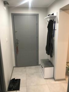 a walk in closet with a door in a room at Apartament, noclegi na doby - Raczki k. Suwałk in Raczki