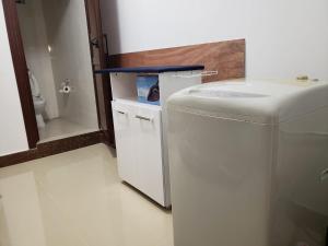 a small bathroom with a washing machine and a toilet at Villa Palmira 6 suites avec piscine 5 min à pied de la plage Pereybere in Pereybere