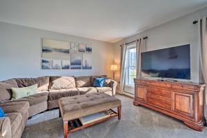a living room with a couch and a flat screen tv at Spacious Home Near Bromley Mountain Ski Resort! in Manchester Center