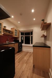 a kitchen with a counter top and a window at Harbour View Apartment in Llandrillo-yn-Rhôs