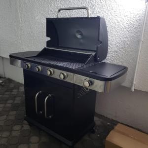 a black barbecue grill sitting on top of a stove at Villa Palmira 6 suites avec piscine 5 min à pied de la plage Pereybere in Pereybere
