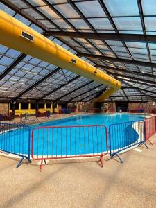 a large swimming pool with a large yellow and blue pool at Lovely 4 berth static caravan, Marine Holiday Park, Rhyl, Wales in Rhyl