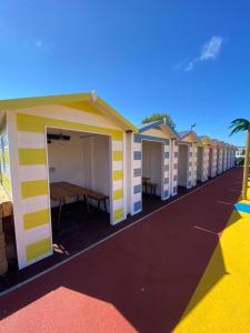 a row of beach huts are lined up in a row at Lovely 4 berth static caravan, Marine Holiday Park, Rhyl, Wales in Rhyl
