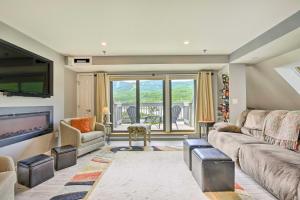 a living room with a couch and a television at Killington Vacation Gem Walk to Ski Lifts! in Killington