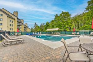 a swimming pool with chairs and a table at Killington Vacation Gem Walk to Ski Lifts! in Killington