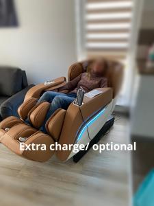 a person sitting on a couch in a chair at Relaxing Coresi Studio in Braşov +56 photos