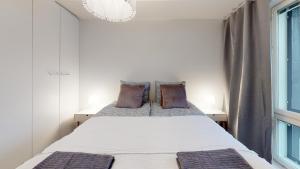 a bedroom with a bed and a window at Bellarova Apartments IV in Rovaniemi