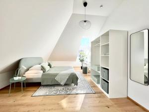 a white bedroom with a bed and a mirror at OrestaLiving - Penthouse in 1020 in Vienna
