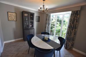 a dining room with a table and chairs and a window at The Nutshell, a Luxury mews property! in Southport