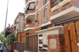 a building with a wooden fence and a gate at Vatican Flat Spacious Cozy with Court in Rome
