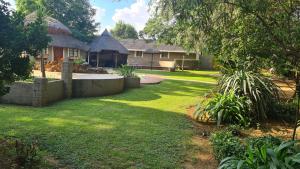 a house with a yard with a yard sidx sidx sidx at Silken Trap Accommodation NO LOADSHEDDING in Johannesburg