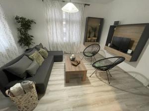 a living room with a couch and a table at Bela Vila in Negotin