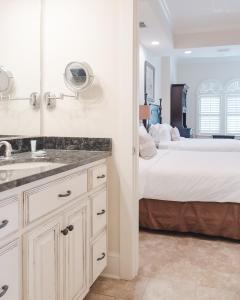 a bathroom with a sink and a bed in a room at Sea Gate Inn in Saint Simons Island