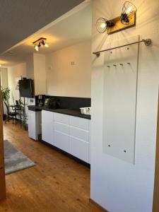 a kitchen with white cabinets and a white door at Urlaub nicht nur für Monteure "K3" in Gera