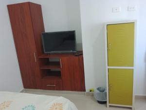 una camera con TV e armadio con televisore di Amplia y bella casa de vacaciones a Flandes