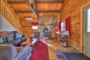 a living room with a couch and a fireplace at Pocono Mountains Cabin with Patio, Near Hiking! in East Stroudsburg