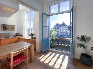 a kitchen with a table and a large window at Appartement spacieux & calme avec vue sur l'Escaut in Tournai