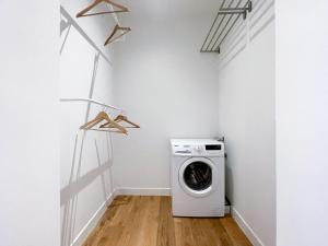 a laundry room with a washer and dryer at Appartement spacieux & calme avec vue sur l'Escaut in Tournai